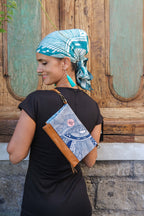 Close-up of the LeMerch Clutch and Scarf featuring an original artistic print, leather trim, and zipper.