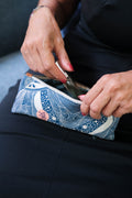 Close-up of the LeMerch Pencil Case featuring an original artistic print, leather trim, and zipper.