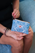 Close-up of the LeMerch Wallet, featuring an original artistic print, leather trim, and zipper.