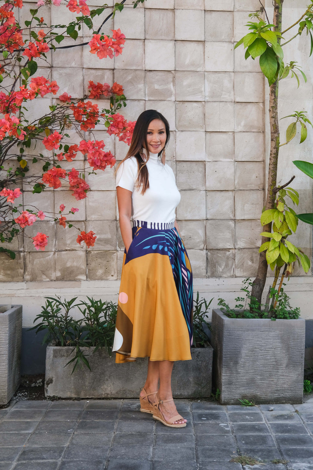 Model wearing in the LeMerch Curated Skirt to showcase its flowing silhouette and original artistic print.