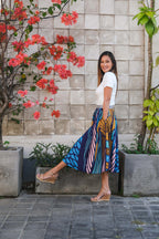 Model showcasing the LeMerch Curated Skirt to showcase its flowing silhouette and original artistic print.