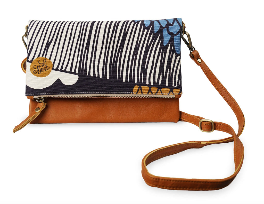 Floral-patterned handbag with brown strap on a white background