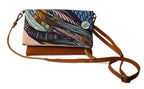 Multicolored patterned handbag with brown strap on a white background