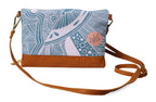 Crossbody bag with blue patterned top section and brown bottom section on a white background