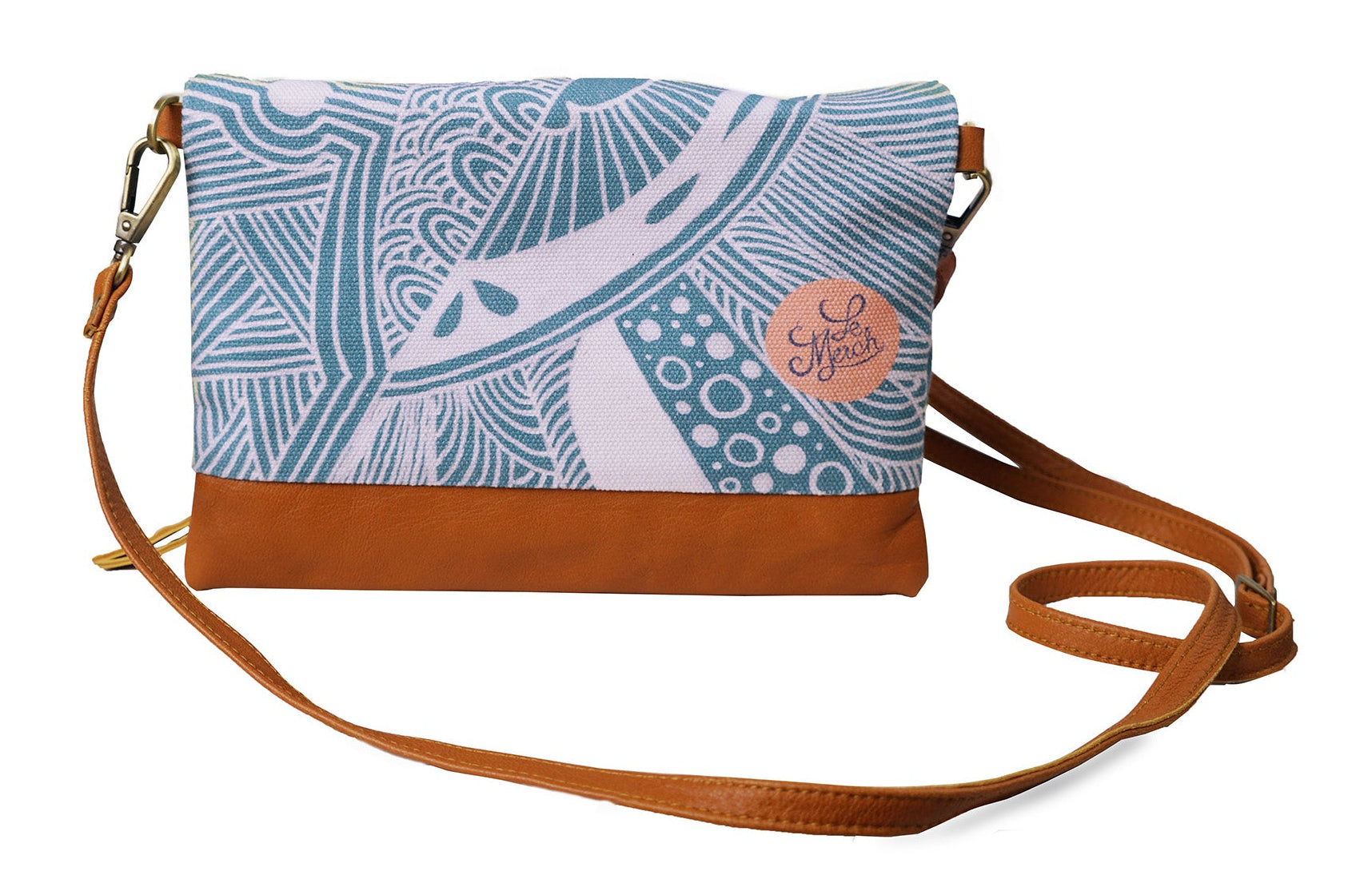 Crossbody bag with blue patterned top section and brown bottom section on a white background
