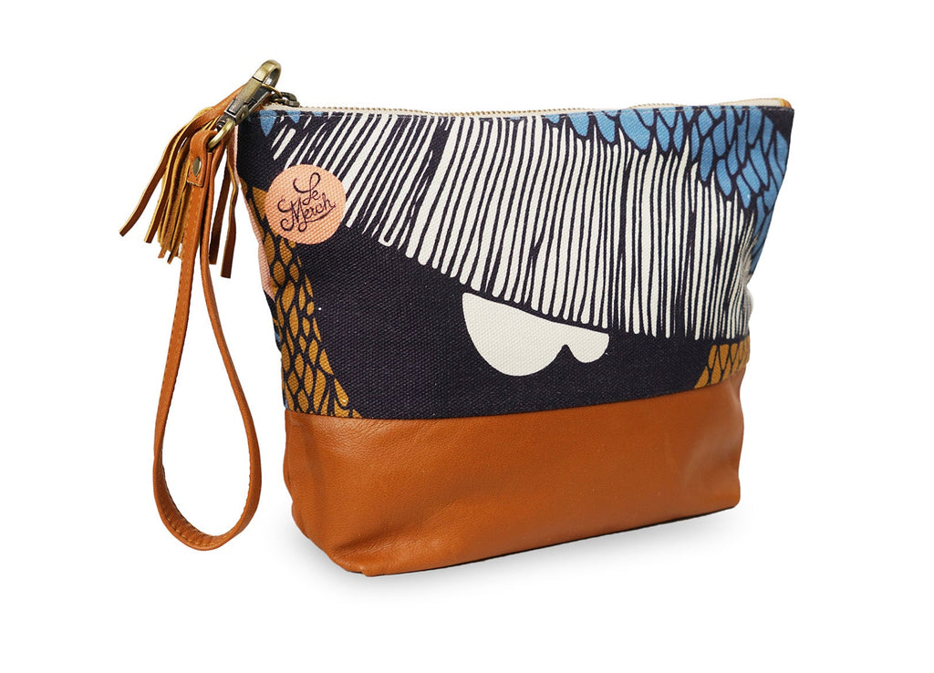 Multicolored clutch bag with a tassel on a white background