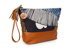 Multicolored clutch bag with a tassel on a white background