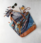 Colorful tote bag with brown accents on a light gray background