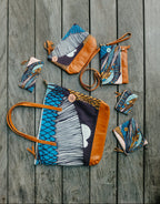 Set of patterned handbags and pouches on a wooden surface